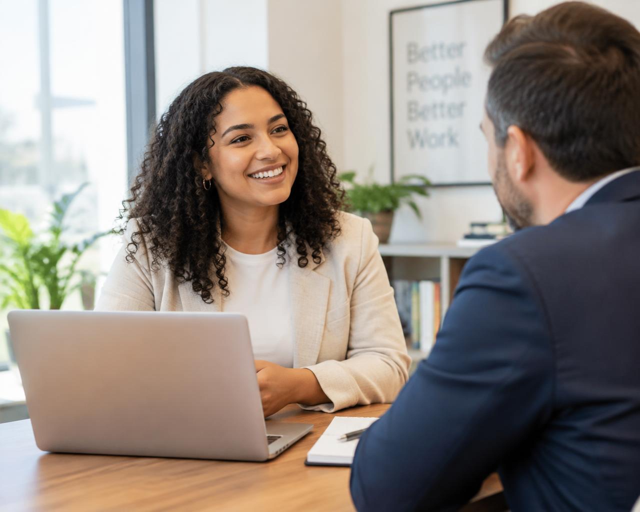 A Talent Scouts recruiter smiling in conversation with a hiring manager